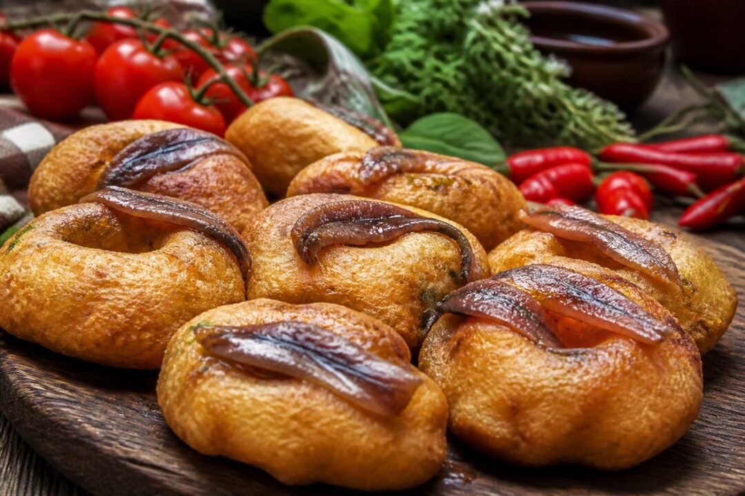 scopri le zeppole calabresi con acciughe, la versione salata della tradizione che unisce sapori autentici e irresistibili per un gustoso viaggio culinario.